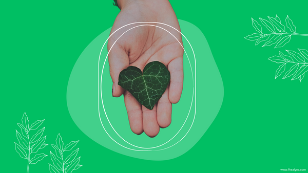 Self-love with nature quotes – A hand holding a heart-shaped green leaf, symbolizing the connection between self-love, nature, and mindfulness, set against a vibrant green background.